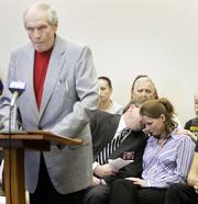 Brandy Sacco, a war widow, right, is comforted by supporters during the testimony of the Rev. Fred Phelps, left, Wednesday in Topeka. Phelps defended his right to picket the funeral of Brandy Sacco's husband, Sgt. Dominic Sacco.