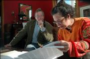 Landlords Tony Backus, left, and his wife, Serina Hearn, review violations and fines of their tenants. Hearn is proposing that the city and KU create a program that would allow KU officials to discipline students for off-campus behavior.