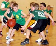 Duck Joshua Hodge grasps for the ball as Spartan Alex Green makes a run to beat him to it. The Spartans won 28-15 at Langston Hughes Elementary.