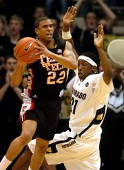 Texas Tech's Jarrius Jackson (22) works around the defense of Colorado's Marcus Hall.
The Buffaloes held off the Red Raiders for a 66-64 victory Saturday in Boulder, Colo.