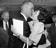 Vice President Lyndon Johnson gets a welcoming kiss from Lady Bird Johnson at Andrews Air Force base in this Aug. 21, 1961, file photo. Presidents who were wild about their wives were not necessarily faithful to them. Lady Bird once shrugged off her husband&squot;s affairs as a "speck on a wedding cake."