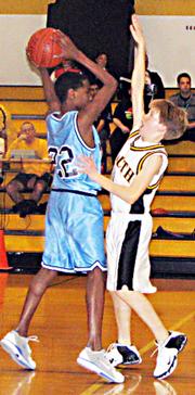West's Kevin Barber looks for a teammate to bail him out from South's Michael McCabe's swarming defense.
