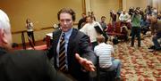 Former Missouri basketball coach Quin Snyder leaves a news conference after discussing details of his resignation. Snyder spoke Tuesday night in Columbia, Mo.