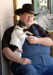 Mike Coffman, of Lecompton, has reached the limit of assistance for his utility bills from ECKAN. Coffman is disabled from injuries resulting from a car accident and cannot work. He is pictured with his dog Butch.