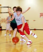 Bryce Montes de Oca attempts to get around the Spartans as he drives the ball to the hoop. The Spartans defeated the Horned Frogs on Feb. 14 at Langston Hughes Elementary.