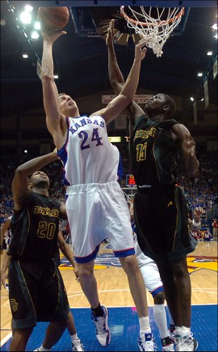 Kansas center Sasha Kaun puts a shot up against Baylor defeners Tim Bush, left, and Mamadou Diene in the first half of play.