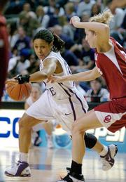 Kansas State's Twiggy McIntyre, left, drives around Oklahoma's Erin Higgins. The Sooners won, 78-64, Tuesday in Manhattan.