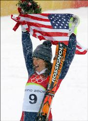 Julia Mancuso of the United States celebrates after winning gold during the flower ceremony for the Women's Giant Slalom at the Turin 2006 Winter Olympic Games in Sestriere Colle, Italy, Friday, Feb. 24, 2006.