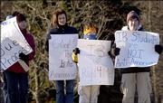 From left, Geralyn Austin, Jane Banse, Will Banse, 11, and Robert Kaufman, 12, all of Upper St. Clair, Pa., parents of students and students in the International Baccalaureate program, protest at the entrance to a school Feb. 17, 2006 in Upper St. Clair. Little battles over the increasingly popular global education program known as International Baccalaureate have been popping up in towns across the country.