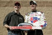 Kurt Busch, left, congratulates brother Kyle for winning the pole position for the 2005 Auto Club 500 at California Speedway.