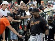 San Francisco Giants' Barry Bonds is greeted by fans as he walks out of the clubhouse to play in his first game of the spring against the Los Angeles Angels in Tempe, Ariz., Thursday March 9, 2006.