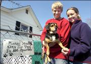 Jared and Whittnie Essner of Scott City, Mo., pose for a photograph in the house they bought with a dog named Rocky, Monday, March 6, 2006, in Scott City, Mo. The 4-year-old beagle mix was written into the real estate contract after the couple became attached to the dog.