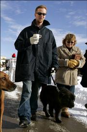Inmate John Manard, left, is followed by Safe Harbor Prison Dog Program President Toby Young as he walks his dog on the grounds of the Lansing Correctional Facility in Lansing, Kan., Dec, 8, 2005. Proclaiming his deep love for "an angel" and continuing to deny that he was a violent criminal, Manard said Wednesday, March 8, 2006, he was solely responsible for his Feb. 12, 2006, escape in a dog crate from this Kansas state prison. In a four-page letter to television station KCTV in Kansas City, Manard said he loved Young, a 48-year-old married mother of two, "more than life" and he planned the escape from Lansing Correctional Facility so he could be with her. KCTV said Manard&squot;s sister verified that the handwriting was her brother&squot;s.