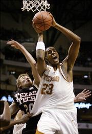 Texas forward LaMarcus Aldridge (23) hauls in a rebound against Texas Tech guard Alan Voskull (20) during the second half their Big 12 Men's Basketball Championship tournament game Friday, March 10, 2006, in Dallas. Texas won the game 77-70.