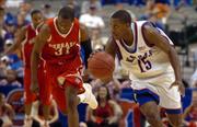 Kansas guard Mario Chalmers breaks up the court past Nebraska guard Jamel White in the second half of play.