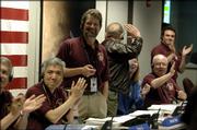 James Graf, standing, project manager of NASA's Mars Reconnaissance Orbiter project, reacts after the spacecraft successfully entered Mars orbit, at NASA's Jet Propulsion Laboratory in Pasadena, Calif., Friday, March 10, 2006.