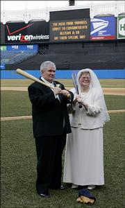 Newlyweds Allison, right, and Ed Lucas pose for photographers on the field of Yankee Stadium after they took their vows, Friday, March 10, 2006, in the Bronx borough of New York. It was a first for the stadium where the knot has been tied in the clubhouse and monument park, but never before on the actual field.