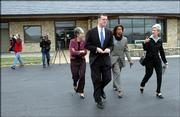From left Senator Marci Francisco, Rep. Paul Davis and Barbara Ballard and Gov. Kathleen Sebelius leave the Lawrence Airport after an earlier fly over of Lawrence and a press conference at the airport. The Gov. toured the damaged areas of the community Monday morning.