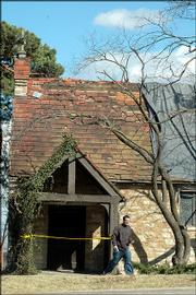 A student passes by Danforth Chapel on the KU campus after taking a photograph of the building damaged in SundayÃs storm.