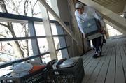 Tony Panos, a KU junior from Chicago, moves items from his apartment at Berkeley Flats apartments, 1123 Ind. Six apartments were so damaged in Sunday's storm that residents had to be relocated. Panos was moving out Wednesday.