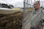 Irvin Lai, of the Chinese Historical Society of Southern California, looks over the site of a subway expansion where remains from an old Chinese cemetery were found. Lai says the Metropolitan Transit Authority should rebury the bodies at Evergreen Cemetery, one of the area's oldest and grandest burial sites.