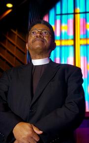 The Rev. Joseph Rembert stands at the altar where Rosa Parks' body lay during a memorial service last fall at St. Paul A.M.E. church in Montgomery, Ala. Lampert has spoken out against a bill that would pardon Rosa Parks and others who were arrested during the Civil Rights Movement.