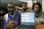 Russell Pleasant, 46, of Bellevue, Neb., left, one of four out of 3 million contest entrants to pick all the teams in this year's Final Four, shows his winning bracket on a laptop computer with his son Russell Jr., 14, and daughter Ashley, 15, in their Bellevue, Neb., home, Sunday, March 27, 2006. A lifelong sports fan who loves Nebraska football and has always rooted for "the old teams" in basketball, Georgetown, UCLA and the like, Pleasant said he never figured he'd have a chance to win the thing.