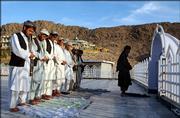 Afghan men pray at a mosque in the center of Kandahar province, southern Afghanistan on Monday, March 27, 2006. An Afghan man who faced the death penalty for converting from Islam to Christianity has appealed for asylum in another country, the United Nations said Monday.