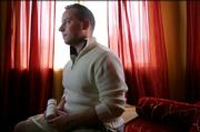 Matthew Bell, 32, a study participant for an AIDS drug that is being tested to prevent infection with HIV, poses for a photograph at his home in San Francisco, Friday, March 24, 2006. Bell is shown holding a container of pills that has a memory chip in the lid that records each time he opens it so doctors can verify when and how often he's taking the drug.
