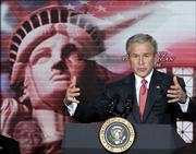 President Bush speaks to newly naturalized citizens at a naturalization ceremony at the Daughters of the American Revolution administration building in Washington Monday, March 27, 2006. President Bush said Monday that overhauling the nation&squot;s immigration laws "is not going to be easy" and warned critics against stoking anti-immigrant feelings by calling them a threat to the nation&squot;s identity or a burden to the economy.