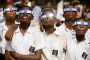 A group of schoolchildren look at the solar eclipse in Accra, Ghana. The students cheered Wednesday as the first total eclipse in years plunged Ghana into daytime darkness, an eagerly awaited solar show that swept northeast from Brazil to Mongolia.