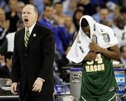 George Mason coach Jim Larranaga, left, yells at his players as Will Thomas covers his head with a towel. Florida beat the upstart Patriots, 73-58, Saturday in Indianapolis.