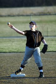 Joseph Mikesic, 11, makes a throw to first base from his second-base position during a practice with his baseball team at the YSI fields