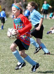 Blue Devil Goalie Addison Campbell runs the ball out for her teammates during Saturday's 10U Club division game against the Blue Phantoms. The Phantoms narrowly won 3-2.
