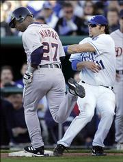 Kansas City Royals first basemanDoug Mientkiewicz (11) tags out Detroit Tigers' Craig Monroe (27) during the eighth inning of their opening day baseball game at Kauffman Stadium in Kansas City, Mo., Monday, April 3, 2006. Mientkiewicz made the tag after being pulled off the bag by a high throw.