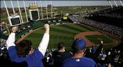 Fans cheer a Kansas City Royals run during the team's baseball home opener against the Detroit Tigers Monday, April 3, 2006, at Kauffman Stadium in Kansas City, Mo. Detroit won the game 3-1.
