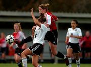 Lawrence High junior Abby Vestal gets off a shot for a goal as she collides with Free State High sophomore Taylor Case. LHS topped Free State, 3-0, Tuesday at Free State.