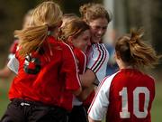 Lawrence High junior Abby Vestal, right of center, hugs freshman teammate Stef Stuever as senior Raya Bowden, left, and sophomore Madison Bertrand come in to celebrate. The Lions beat Free State, 3-0, Tuesday at Free State's field.