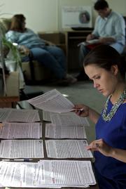 Karen Myers counts some of the 6,500 names on petitions to the District Court of Sedgwick County. The petition calls for a grand jury probe into the death of a mentally disabled woman who died in 2005 after having an abortion at a Wichita clinic.