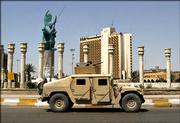U.S. soldiers in a Humvee patrol past the sculpture nicknamed "Freedom," which was put up to replace the statue of Saddam Hussein pulled down by three years ago Sunday in Baghdad, Iraq. Three years after the statue came down, symbolizing the defeat of Saddam Hussein&squot;s regime, Iraqi politicians were scheduling meetings to try to resolve the deadlock over who will be the country&squot;s next prime minister. The new statue features an angelic woman holding up a sicklelike moon symbolizing Islam and a Sumerian sun as an emblem of Iraqi national pride.