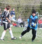 Force goalkeeper Jackson Mercer grabs a wild shot from a Striker player while his teammate stands on the defensive. The Blues went scoreless in their opening game, falling to the Strikers, 10-0.