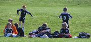 The 9U Kaw Valley Force team hangs out on the sideline before the start of their first game against the Shawnee Elite Vipers Saturday at Youth Sports Inc. in the Kaw Valley Cup Tournament.