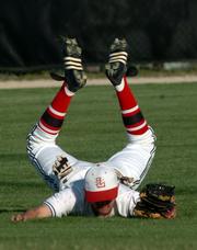 Lawrence High's Brian Heere flops after catching a pop-up in the second inning. Despite the defensive gem, the Lions fell to Free State, 12-1, Tuesday at Ice Field.