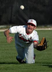 Lawrence High's Brian Heere lays out for a second-inning pop fly. Heere caught the ball, ending the inning.