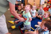 Josh Evans listens to his kindergarten teacher, Linda Browning, at Langston Hughes School. Joshua returned to school Tuesday after a trip to Disney World in Florida.