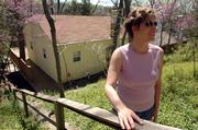 Carol Dengel, of Overland Park, has something she wants to sell on eBay: a Lone Star Lake cabin once owned by the late author William S. Burroughs. Dengel, who is asking about $160,000 for the abode, is pictured on Wednesday at the lake-front property.