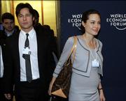 Brad Pitt, left, walks with Angelina Jolie at the World Economic Forum in Davos, Switzerland, in this Jan. 26, 2006 file photo. A local governor in Namibia said Angelina Jolie and Brad Pitt told him they will have their baby in his country and are considering giving it a Namibian name, a newspaper reported Sunday April 16, 2006. Samuel Sheefeni Nuuyoma, the governor of the Namibian province where the couple is staying at a heavily guarded lodge, said he met with the two stars on Friday, according to The Sunday Times of South Africa.