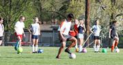 KSA Fury coach Mark Francis demonstrates a ball handling drill for his team. The Fury practice at available soccer fields around Lawrence. They then travel for their game, which mostly take place at Heritage Soccer Park in Olathe.
