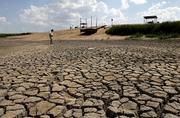 The lakebed at the Hodgeman County State Fishing Lake and Wildlife Area near Jetmore is nearly dry. The state may face continued dry conditions this summer if a long-term weather forecast issued Monday holds true.