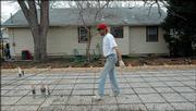 In North Lawrence, Terry Baugher, of Slavin Flatwork Inc., Baldwin, lays down materials for the first floor of a house under construction at 537 Elm St. by Lawrenz Construction.